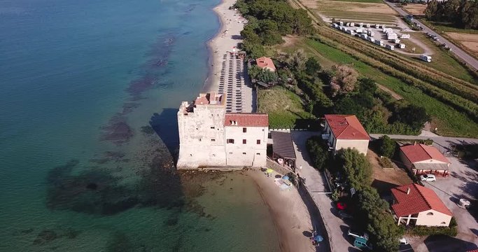 Torre Mozza, Piombino, Toscana, Italy  16 June 2018. Aerial view on the sea, beach and ancient fortress at morning light