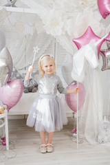 Happy girl holding a magic wand and a unicorn horse
