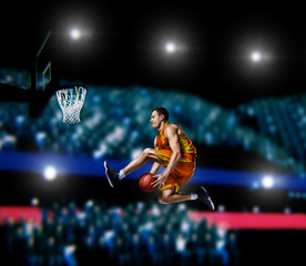 basketball player making slam dunk on basketball arena