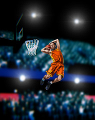 basketball player making slam dunk on basketball arena