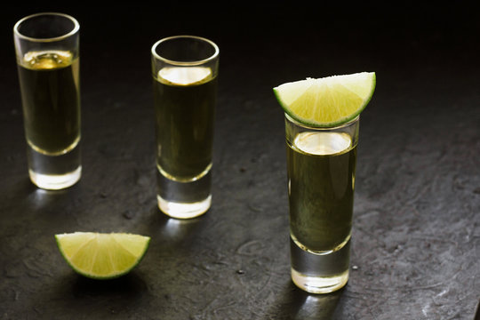Tequila shot, mexican Alcoholic strong drinks and pieces of lime with salt in mexico