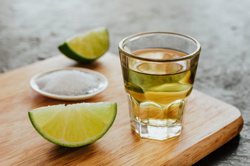 Tequila shot, mexican Alcoholic strong drinks and pieces of lime with salt in mexico