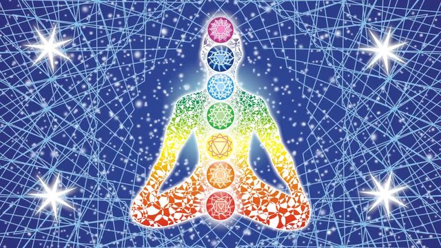 Silhouette of yoga in the lotus position against the background of a rotating mandala and the starry sky. In the background, the sun-aura flashes in time with the breath. 7 чакр с символами. Video.