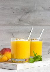 Peach dessert (mousse) with natural yoghurt, walnuts and mint in portion glasses