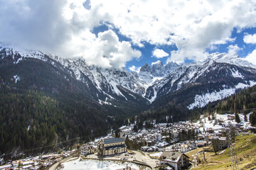Falcade panoramic view. Winter city in the mountains. Italy, Alps, Dolomites, Falcade. Falcade winter landscape,Dolomites; winter white view of touristic village in Dolomites,shot under deep blue sky.