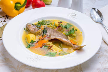 Fish soup on white plate