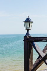 Street lamp against the background of the sea.