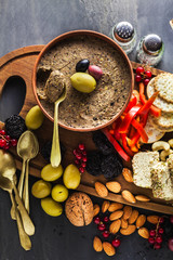 appetizer of olives for an aperitif. healthy vegan pate on the table with other snacks