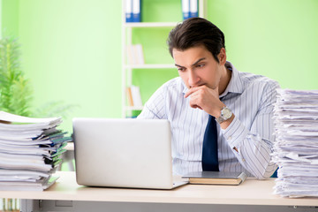 Businessman having problems with paperwork and workload
