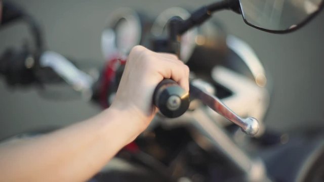 close-up female hands on a motorcycle
