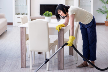 Senior old woman tired after vacuum cleaning house