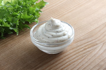 Fototapeta na wymiar mayonnaise sauce, sour cream on a wooden background