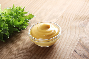 mustard sauce on a wooden background