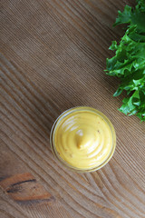 mustard sauce on a wooden background