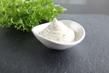 mayonnaise sauce, sour cream on a stone background