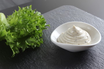 mayonnaise sauce, sour cream on a stone background
