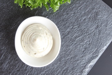 mayonnaise sauce, sour cream on a stone background