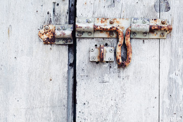 close up of rusty padlock wall background