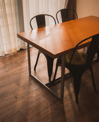 Dining table in the Cozy room on wooden floor.