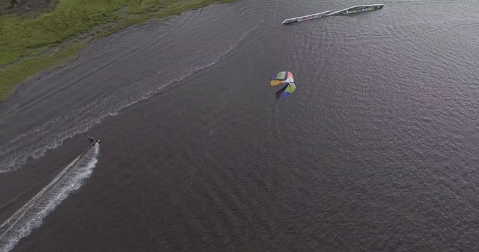 Closeup aerial view of a kiteboarder grinding a rail in a sound in the Outer Banks, NC.