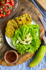 Fresh homemade bread of whole wheat flour with turmeric powder, parsley and garlic on plate with fresh green salad leaves. Vegetarian lunch and vegan dinner. Paleo healthy food diet