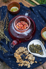 Asian tea ceremony. Japanese, Chinese and Thai traditional tea ceremony with pot and small cups. Herbal green and black Chinese tea leaves, aromatic drink, authentic