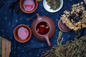 Asian tea ceremony. Japanese, Chinese and Thai traditional tea ceremony with pot and small cups. Herbal green and black Chinese tea leaves, aromatic drink, authentic