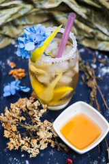 Sweet fruity cocktail drink without sugar with honey, ginger, lemon (lime) and mint. Herbal Chinese tea with tropical fruits. Asian cafe refreshing drinks menu. Vegan vegetarian food and beverages. 