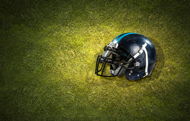 American football helmet on grass