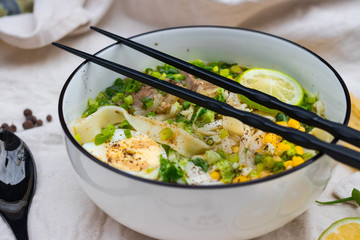 Ramen noodle soup with egg, corn and meat in bowl. Asian Thai traditional authentic food with vegetables served in cafe or restaurant