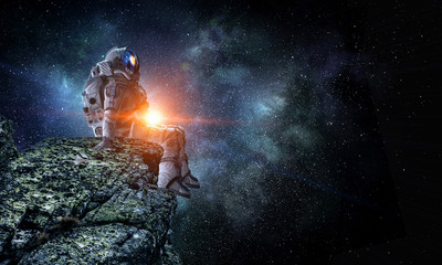 Spaceman on rock edge. Mixed media