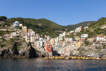 Fototapeta premium Stunning view from the sea of the Riomaggiore village in the Cinque Terre in Liguria, Italy
