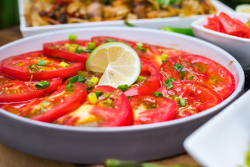 Asian vegetables tomato salad with soy sauce, lime and herbs. Thai traditional spicy food menu at cafe. Raw vegan vegetarian food