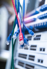 network cables and hub closeup with fiber optical background