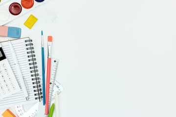elementary school supplies on white background, flat view