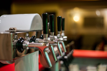 close up draft beer and lemonade dispensing tower of bar restaurant