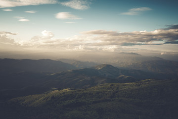 Fototapeta premium Beautiful mountain landscape under sky with clouds in sunlight. vintage filter effect.