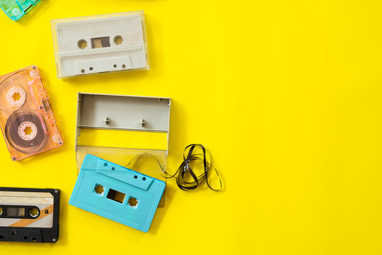 vintage tape cassette recorder on yellow background, flat lay, top view. retro technology