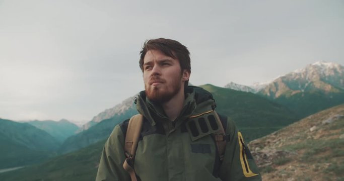 Porttrait of Handsome confident climber in mountains. Adventurer in expedition. Freedom, zen concept 4k