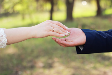 happy couple. Hands of a guy and a girl.Walk by the hand