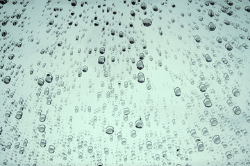 Naklejka na ściany i meble Raindrops on glass car texture.