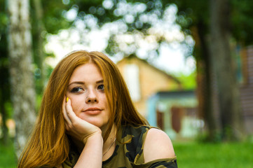 Pretty redhead girl shoot on outdoor park