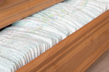 Baby diapers in the dresser, scarves and diapers
