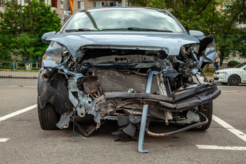 The car is broken in front, the hood, the radiator, the headlights, the bumper, the engine