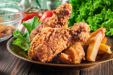 Crispy fried kentucky chicken legs with french fries