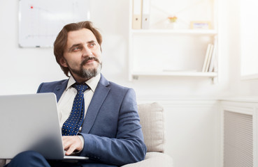 Concentrated businessman working with laptop