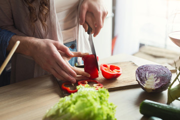 Closeup of couple cooking healthy food together