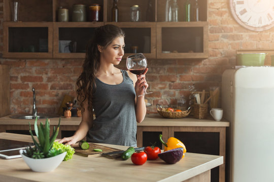 Happy woman preparing healthy food in kitchen