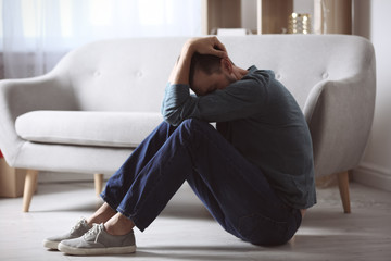 Lonely man suffering from depression at home