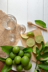 Lemon and leaf on white wooden background